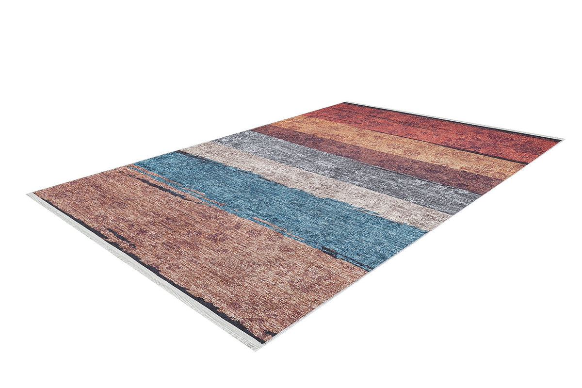 The Urban Edge - Washable Rug - JR2005 is a multicolor flat weave area rug with horizontal stripes in rust, blue, gray, and brown. It features a textured, distressed pattern and fringed edges, shown on a white background.