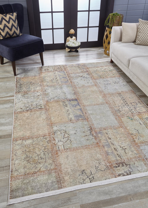 Load image 1 in gallery view. A modern living room features the Urban Utopia - Washable Rug - JR1957 in cream and beige on a light wood floor, paired with a dark blue chair with a chevron pillow, white sofa, potted plant, and double frosted glass doors.
