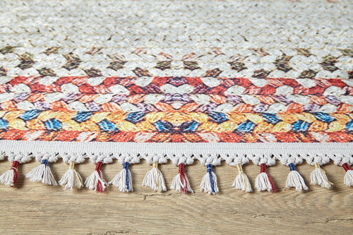 Bild 1 in Galerieansicht laden. The Vibrant Rainbow - Machine-Washable Rug (JR5001) showcases bold geometric patterns in orange, yellow, red, and blue with a white tasseled fringe accented by blue, red, and beige—ideal for high-traffic wooden floor areas.