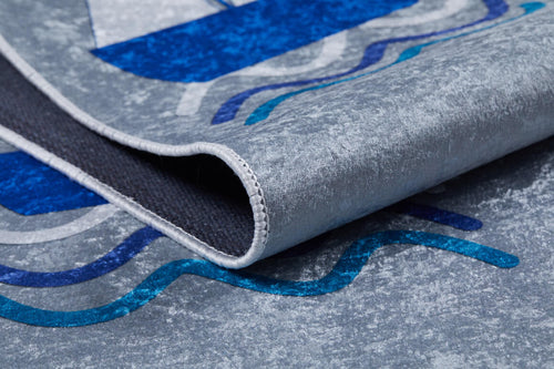 Load image 1 in gallery view. A close-up of the WaveVenture - Machine-Washable Rug JRC087 shows its gray and blue abstract pattern, textured surface, and curved edge—ideal for high-traffic areas.