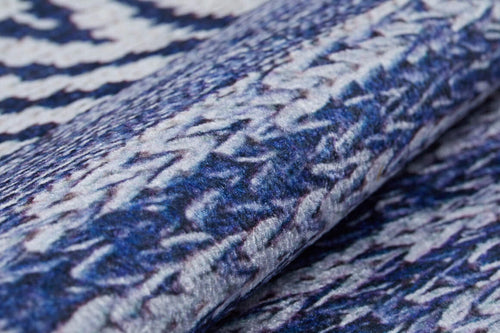 Load image 1 in gallery view. Close-up of the Wavy Wonders - Washable Rug - JR941, featuring a textured blue surface with white and purple zigzag patterns. The detailed weave and raised design make it perfect for high-traffic areas.