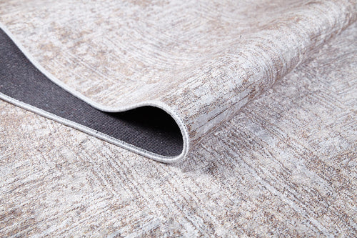 Load image 1 in gallery view. A close-up of the Wildflower Fields - Washable Rug - JR1632 in cream and beige shows one corner folded to reveal a dark non-slip backing. The flat weave's texture is clearly visible on this washable rug.