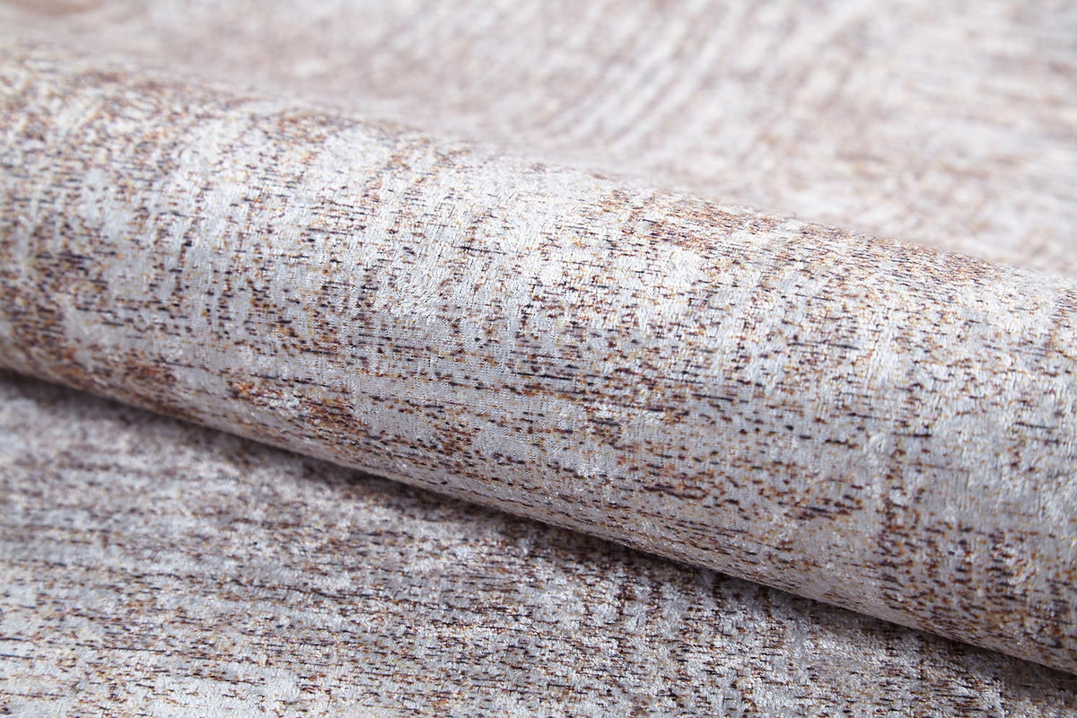 A close-up of the Wildflower Fields - Washable Rug (JR1632), showcasing its subtle light brown and beige pattern with a slight metallic sheen and fabric-like texture, reminiscent of cream and beige rugs.