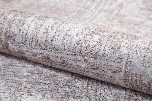 Load image 1 in gallery view. A close-up of the Wildflower Fields - Washable Rug (JR1632), showcasing its subtle light brown and beige pattern with a slight metallic sheen and fabric-like texture, reminiscent of cream and beige rugs.