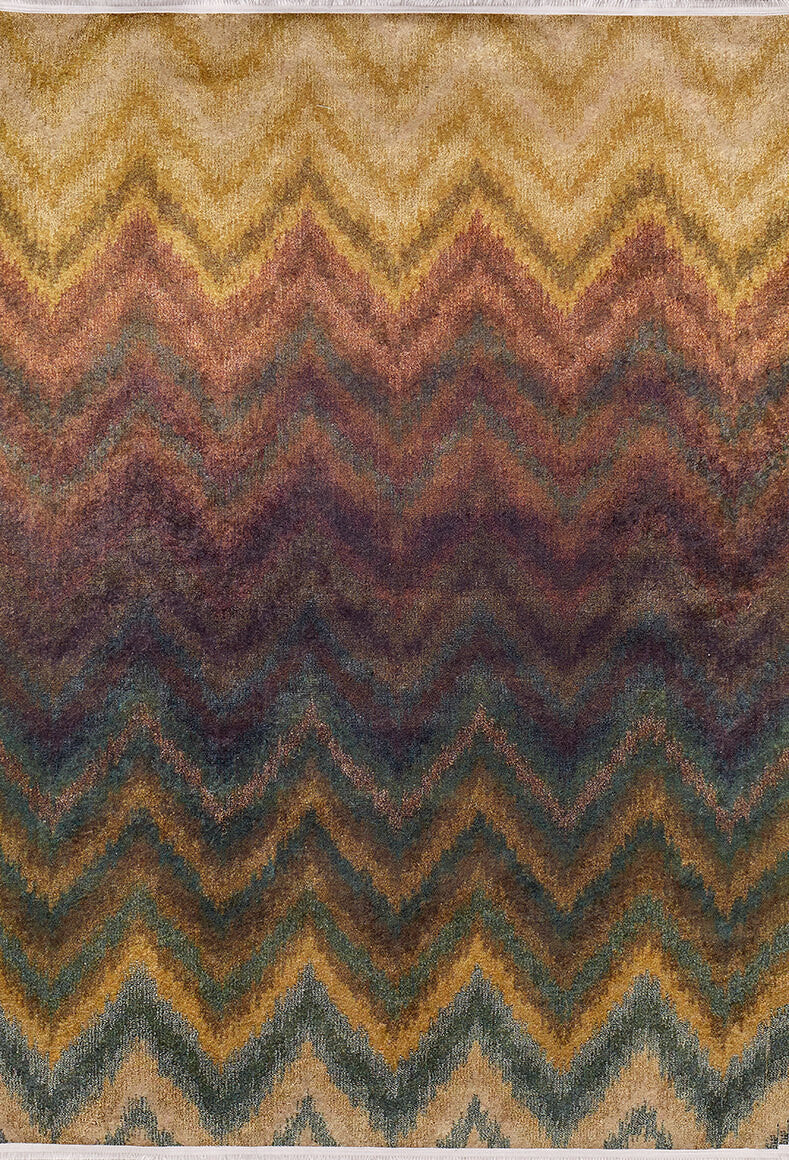 The Zigzag Runway - Washable Rug - JR388 features a textured chevron pattern in earthy zigzag stripes—yellow, gold, brown, burgundy, green, and blue—that blend from light to dark shades, ideal for high-traffic areas.