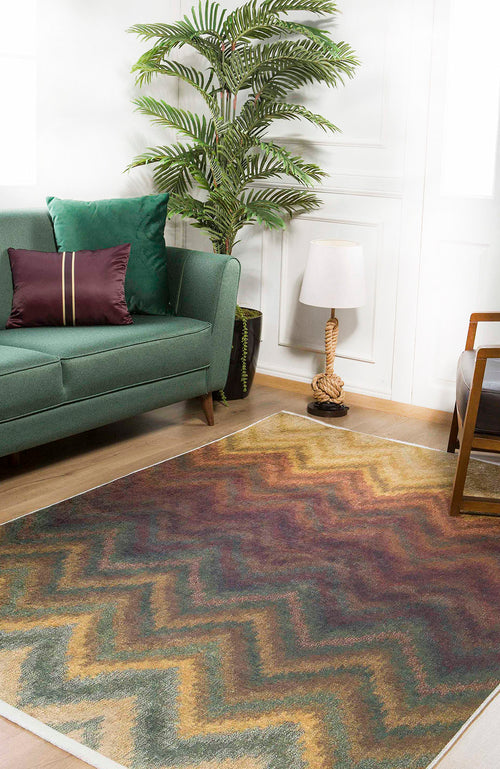 Bild 1 in Galerieansicht laden. A modern living room features a green sofa, purple pillow, potted plant, rope-style table lamp, and armchair. The Zigzag Runway - Washable Rug - JR388 in earthy tones is ideal for high-traffic areas and covers the wooden floor.