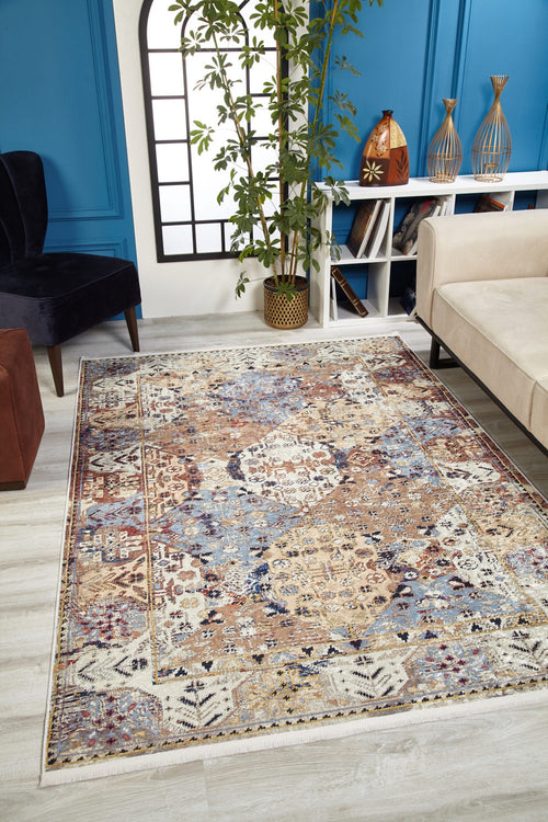 Load image 1 in gallery view. The Native Nature's - Washable Rug - JR1666 adds vibrant pattern to a modern living room with light wood floors, blue walls, a beige sofa, black chair, potted plant, and decor on a white console.