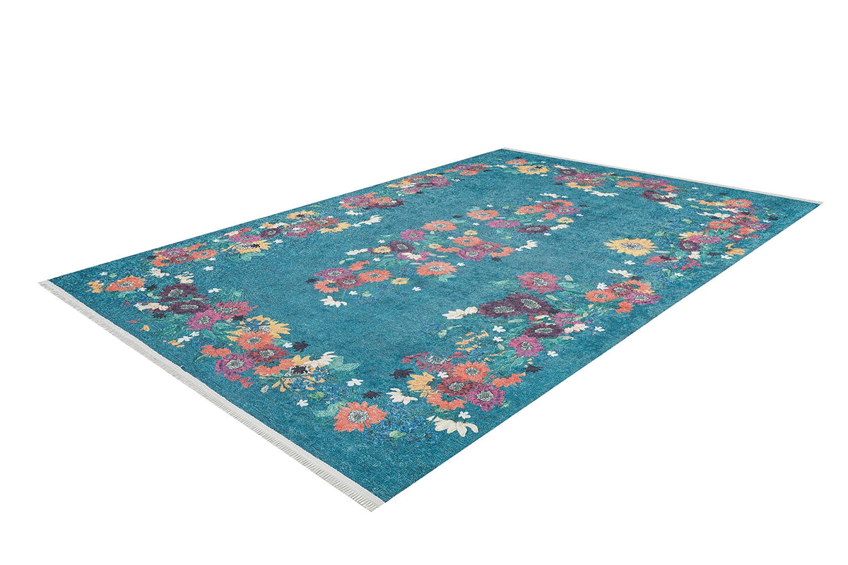 The Nature's Tapestry - Washable Rug - JR1674 is a rectangular blue rug with a floral border of pink, orange, purple, and white flowers. Its mostly clear center and washable design make it ideal for high-traffic spaces.