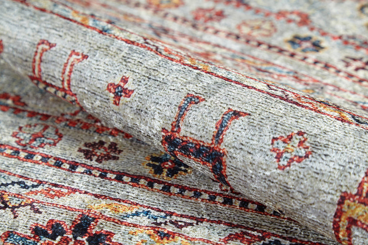 A close-up of the Nomad's Nest - Washable Rug - JR5088 highlights intricate geometric and floral designs in red, yellow, navy, and beige—showcasing its detailed woven texture, perfect for high-traffic areas.
